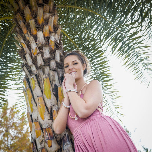 young woman wearing a stack of calming howlite and lava stone bracelets