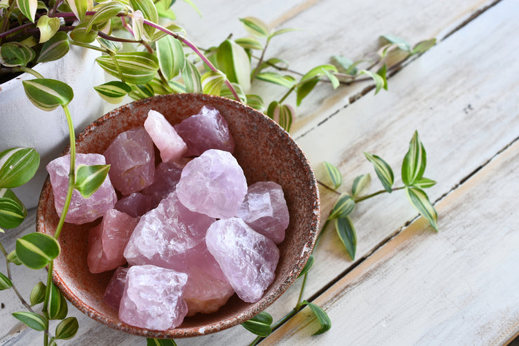 Collection of Rose Quartz gemstones in a bowl.